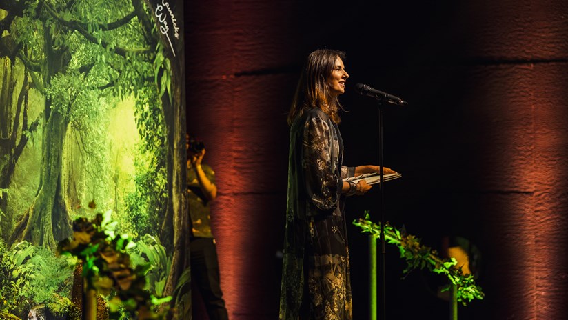 Jessica Christensen talking on stage at an event