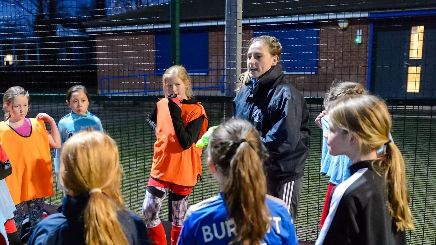 Woman coaching girls football