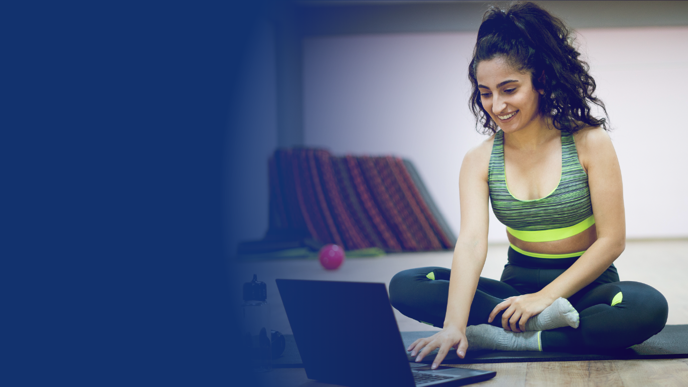 A person exercising and looking at data on a laptop