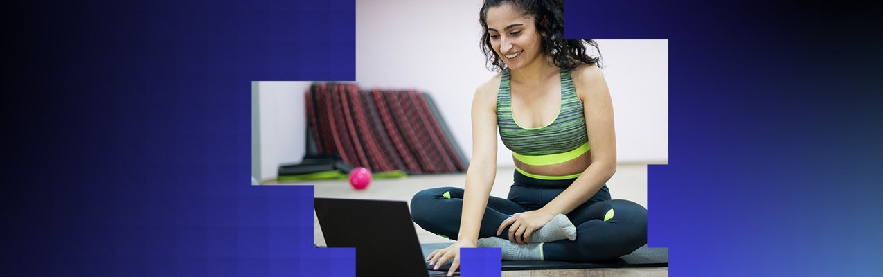 A person exercising and looking at data on a laptop