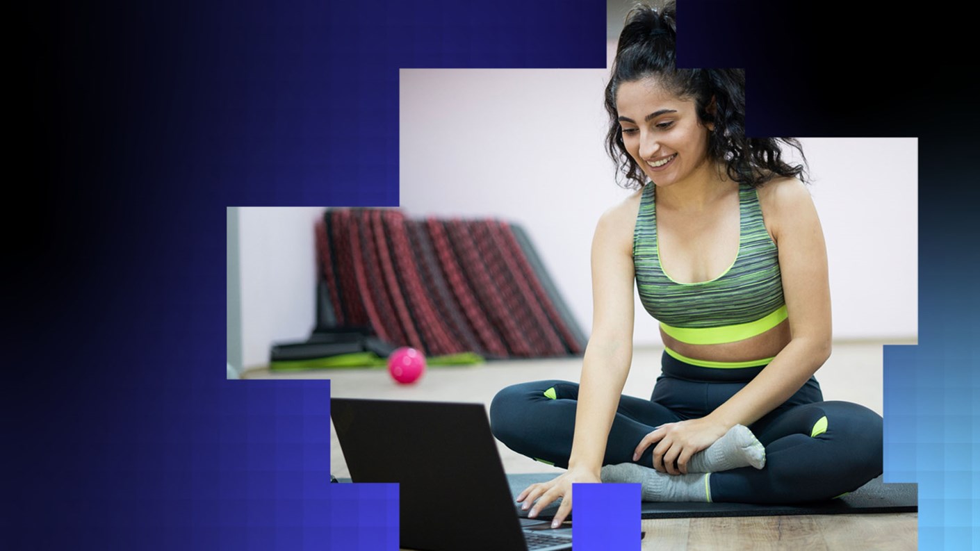 A person exercising and looking at data on a laptop