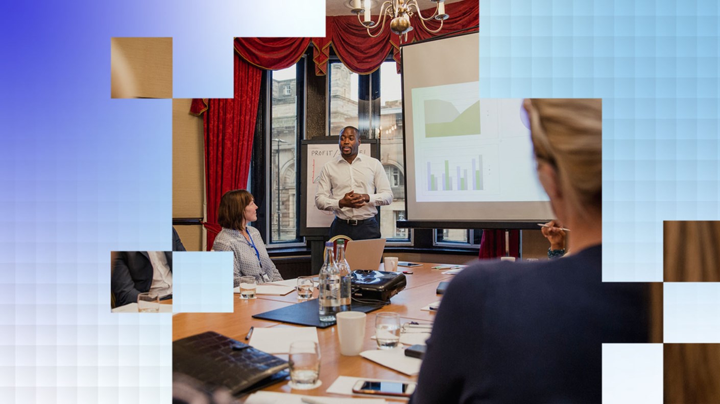 A group of people in a boardroom discussing data