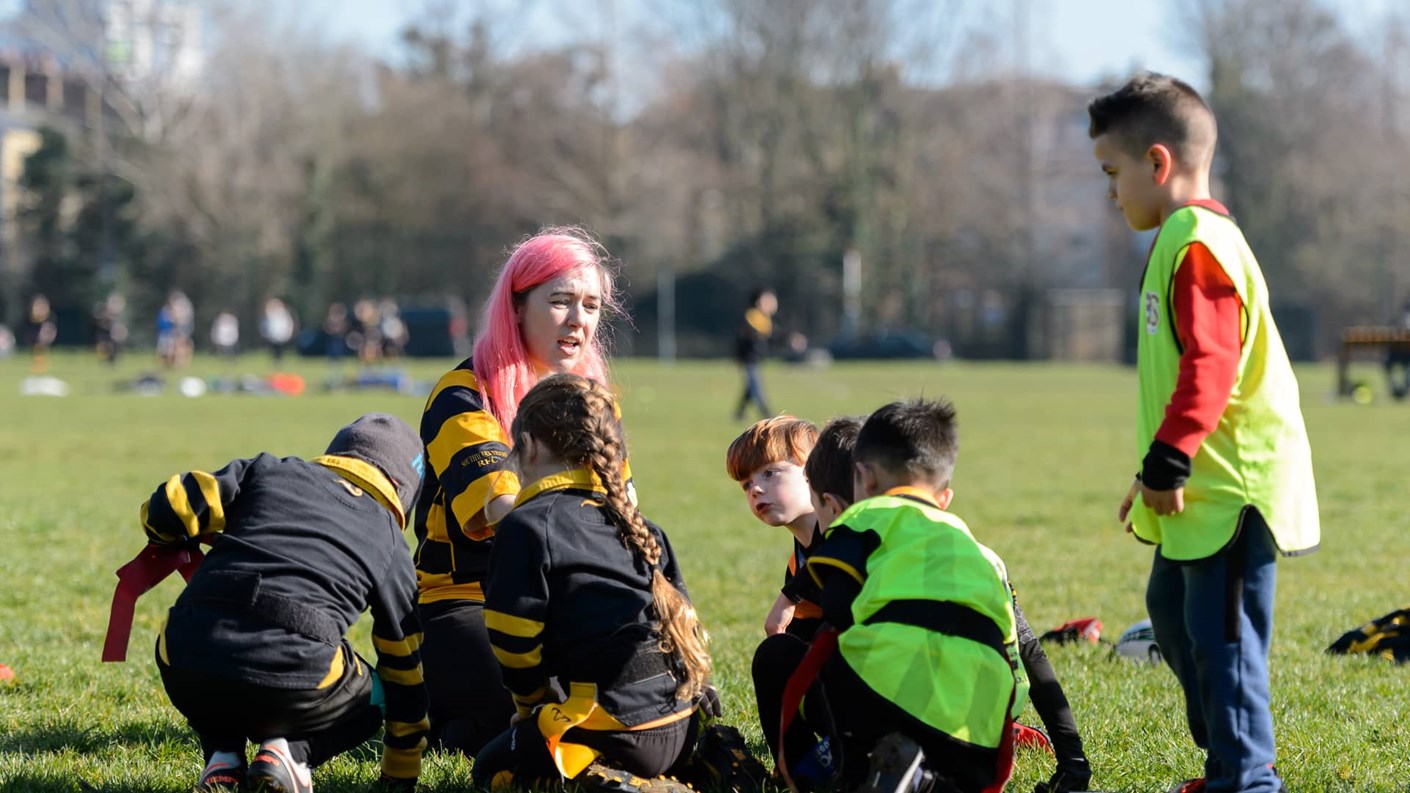 Women coaching children